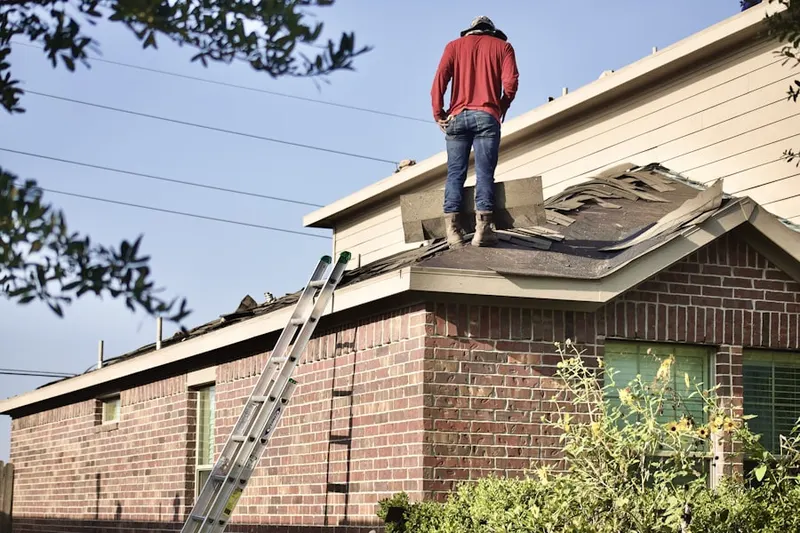 Professional roofer working on a residential roof in Eastwood Manor